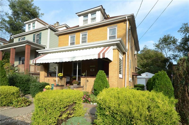 Front of all brick home with large covered front porch! Great way to relax!