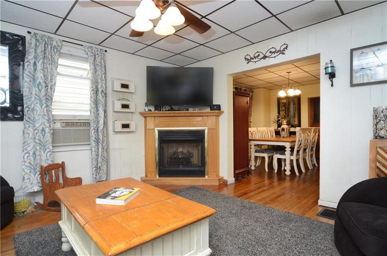 Living room hosts a working gas fireplace for those chilly fall days and cold winter nights. Great flow from the entryway to the dining room area!