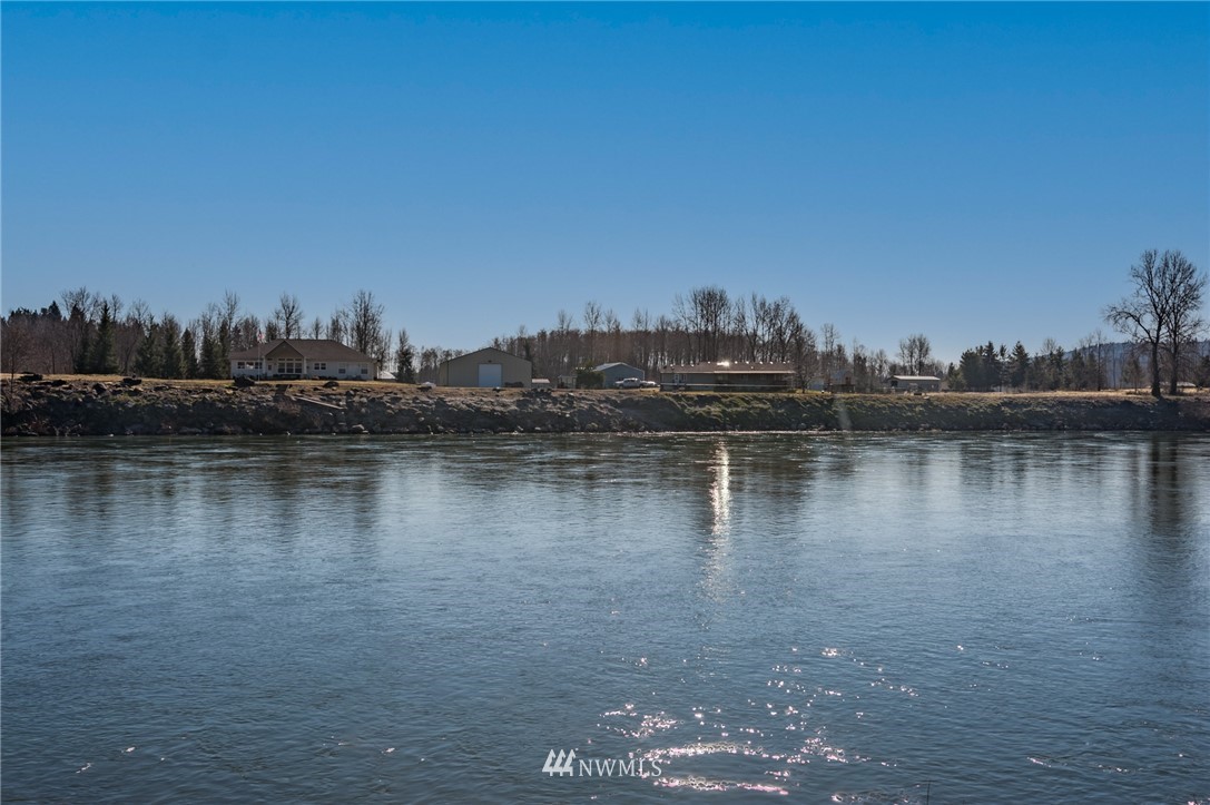 126 Chelsea Road Castle Rock, WA 98611 - Photo 1 of 34 a view of a lake with boats and trees in the background