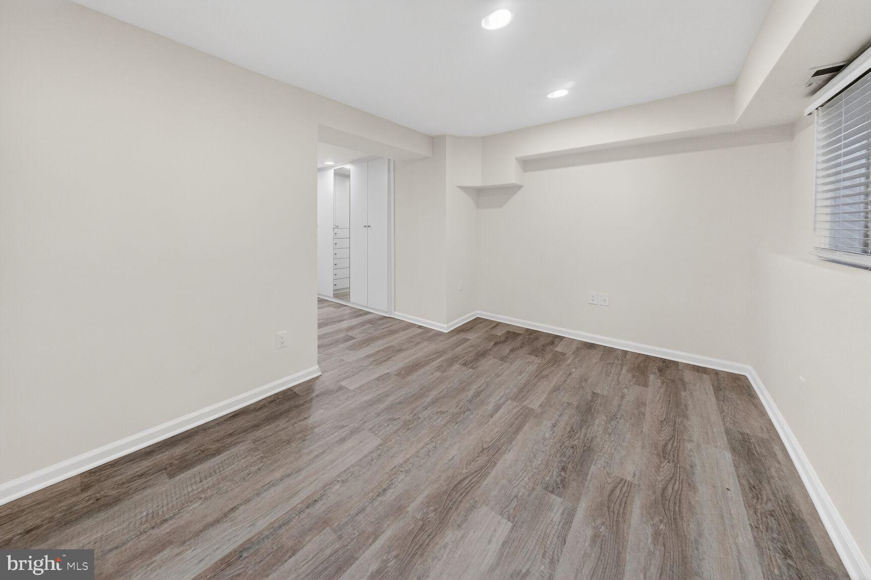 456 M Street Northwest, Unit 1 Washington, DC 20001 - Photo 13 of 19 a view of an empty room with wooden floor and a window