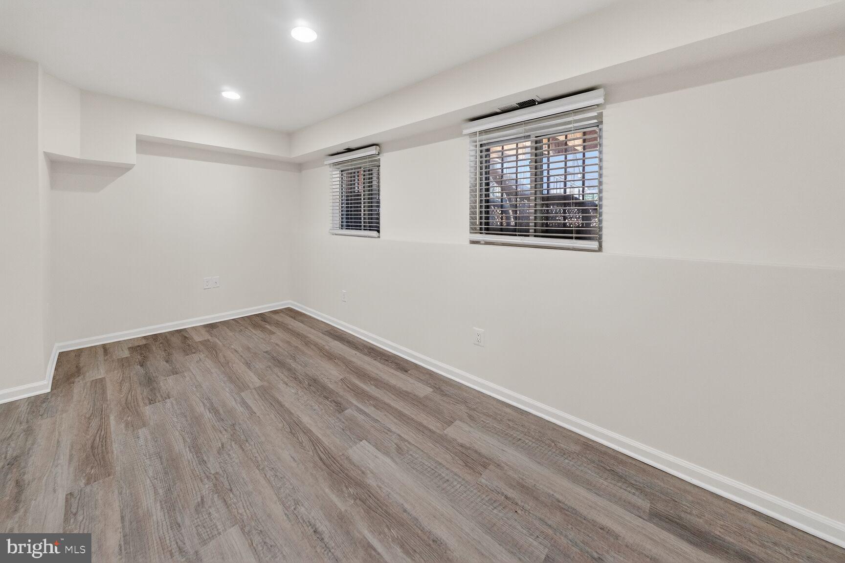 456 M Street Northwest, Unit 1 Washington, DC 20001 - Photo 14 of 19 a view of empty room with wooden floor and fan