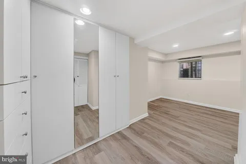 a view of hallway with wooden floor