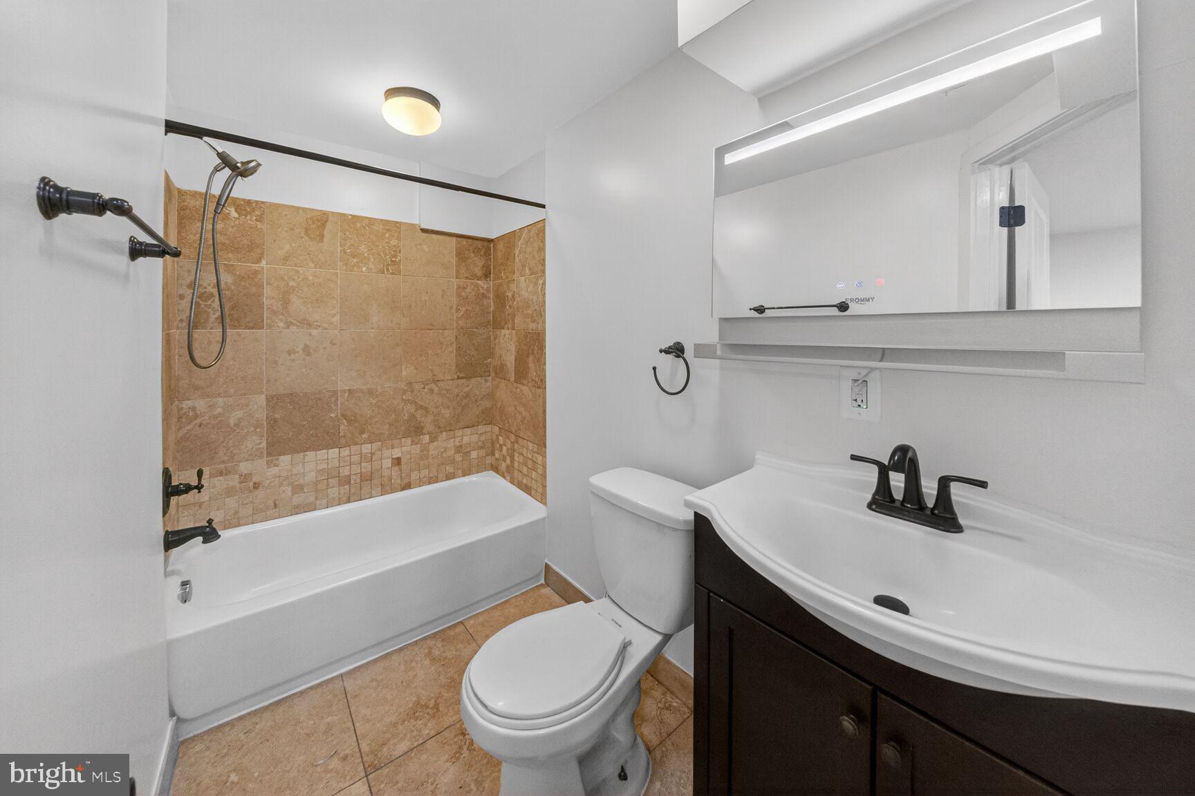 456 M Street Northwest, Unit 1 Washington, DC 20001 - Photo 16 of 19 a bathroom with a sink a toilet and a bathtub