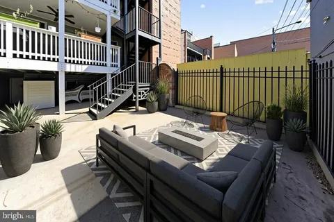 a roof deck with a table and chairs