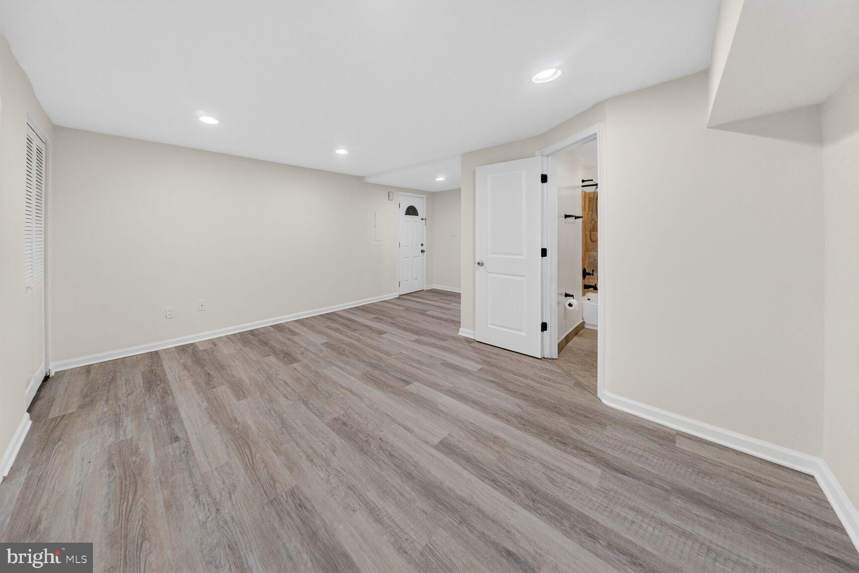 456 M Street Northwest, Unit 1 Washington, DC 20001 - Photo 4 of 19 a view of a room with wooden floors and white walls
