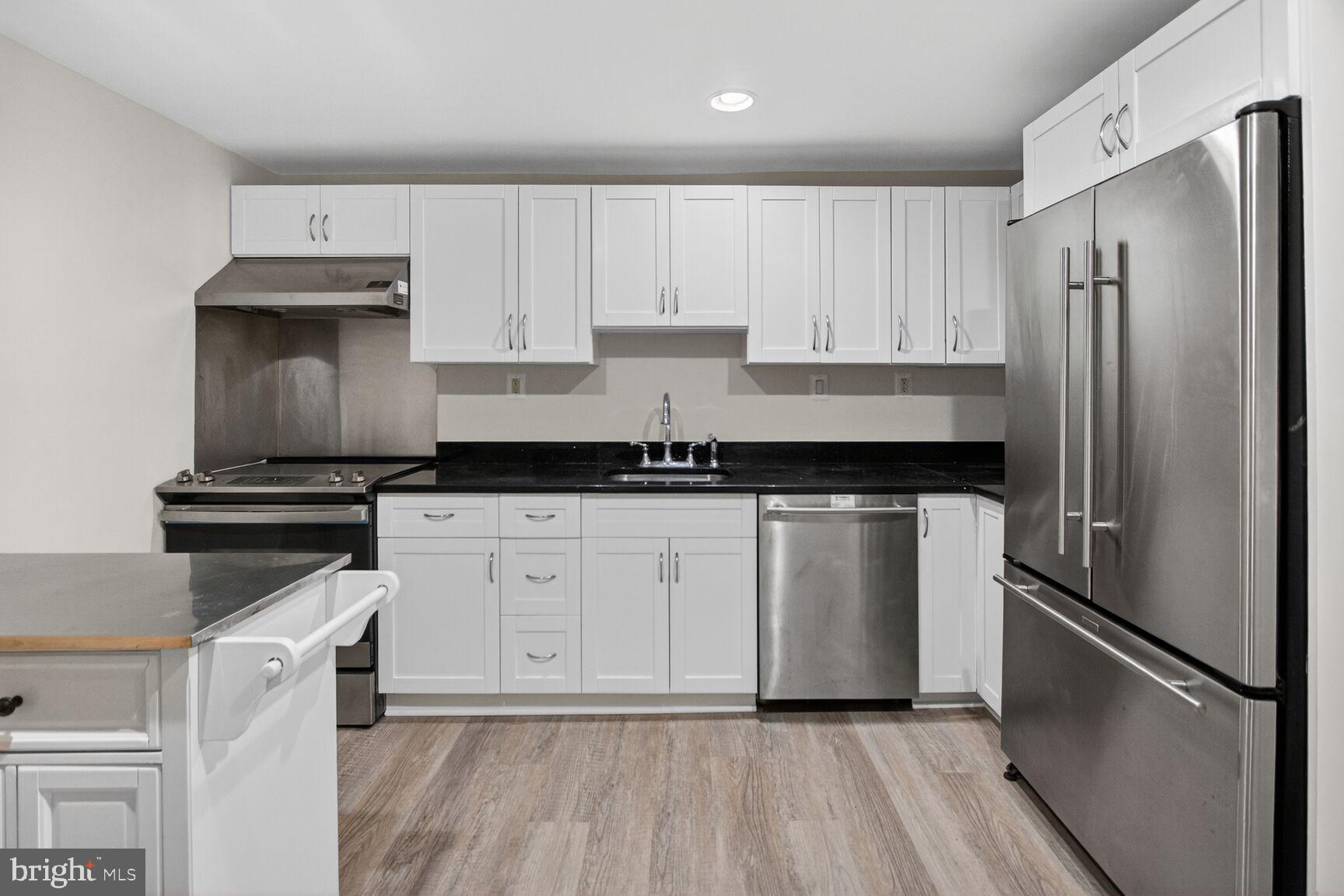 456 M Street Northwest, Unit 1 Washington, DC 20001 - Photo 5 of 19 a kitchen with a refrigerator sink and cabinets