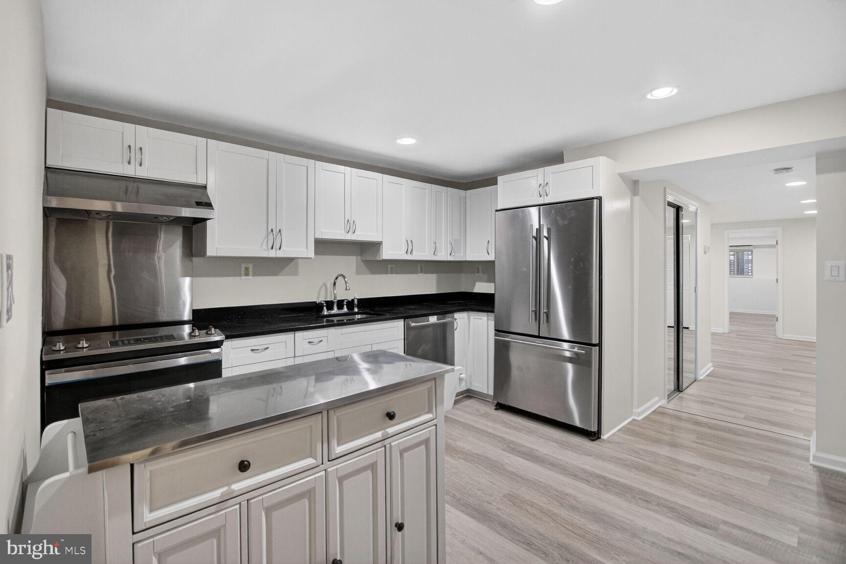 456 M Street Northwest, Unit 1 Washington, DC 20001 - Photo 6 of 19 a kitchen with a refrigerator and a sink