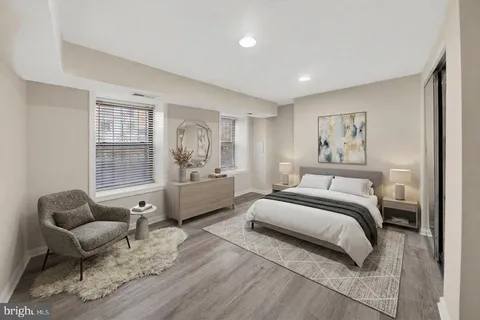 a spacious bedroom with a bed and glass window