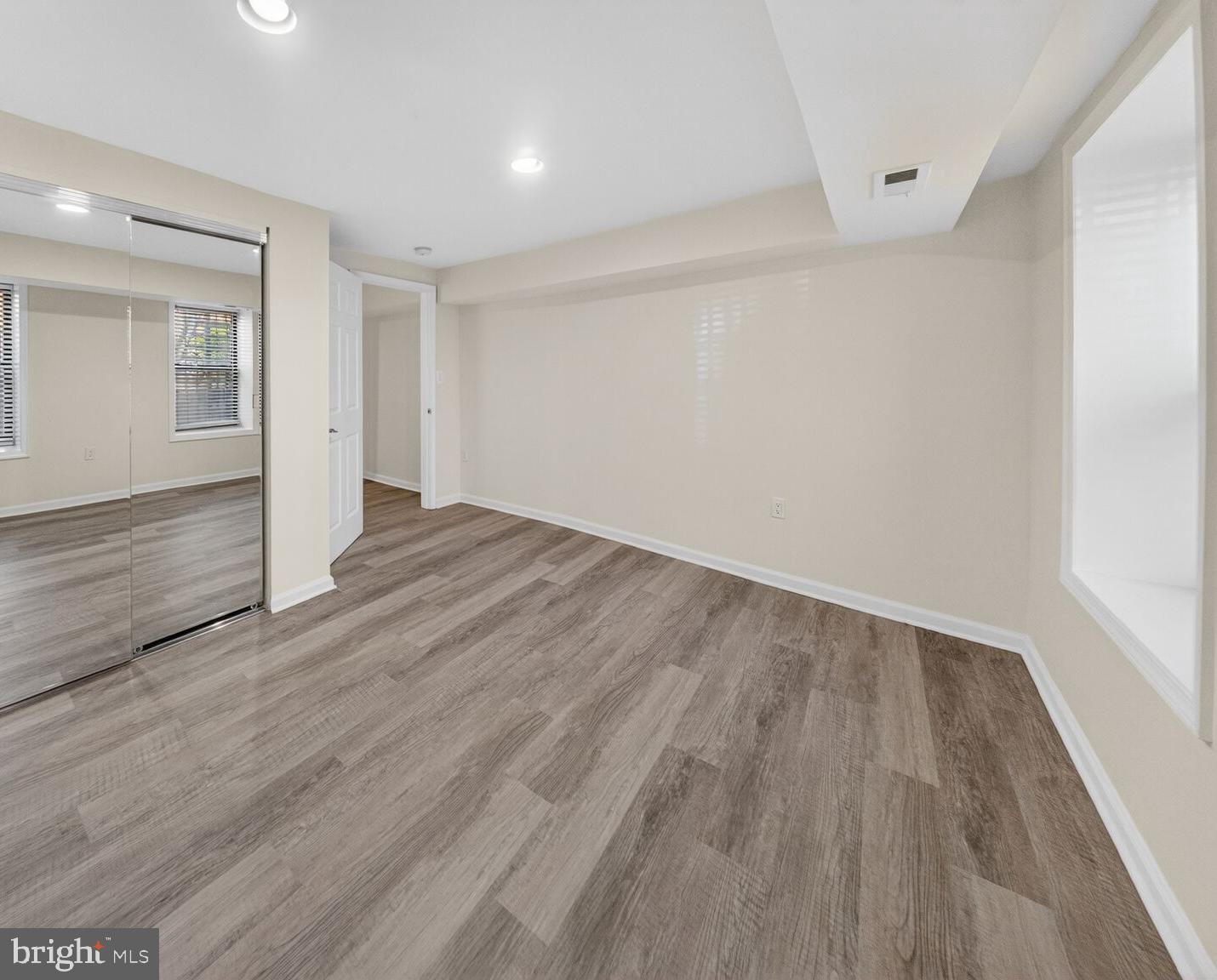 456 M Street Northwest, Unit 1 Washington, DC 20001 - Photo 10 of 19 a view of an empty room with wooden floor