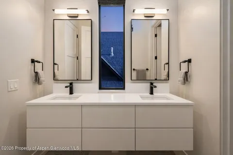 a bathroom with a sink vanity and a mirror