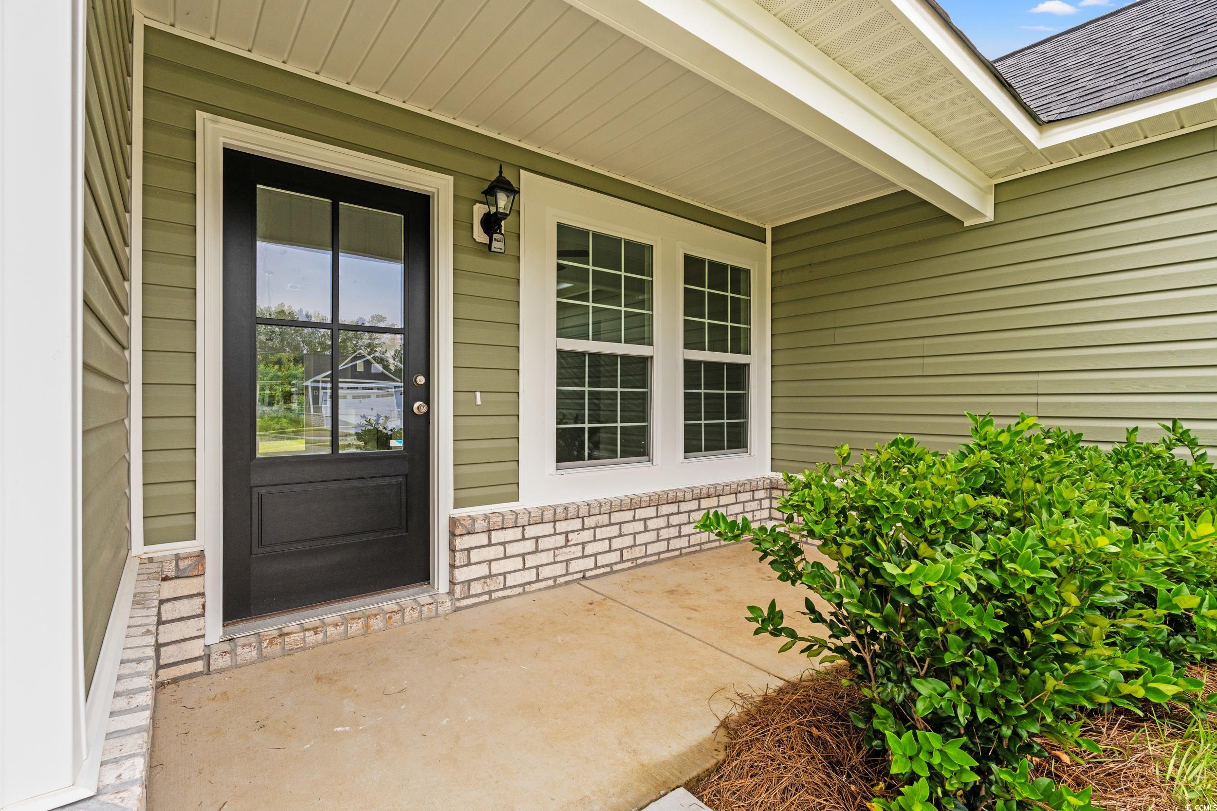 2827 Biscane Court Conway, SC 29527 - Photo 4 of 31 View of exterior entry with a porch and a shingled roof