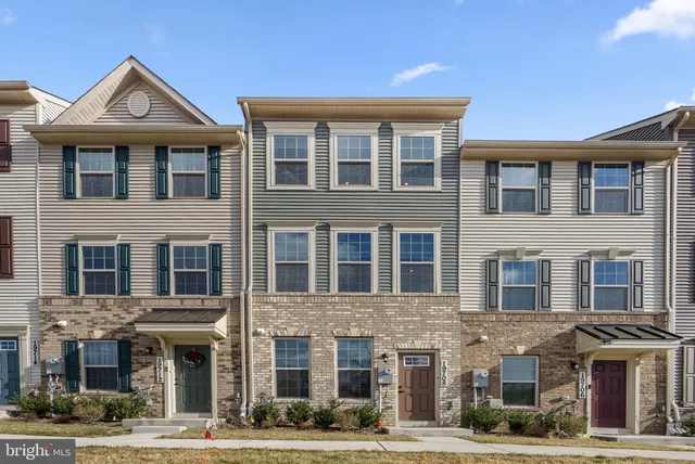 a front view of a building with a yard