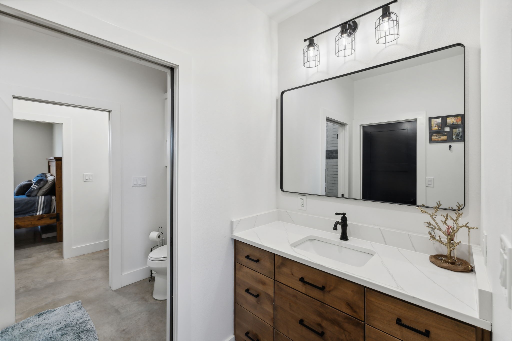 10433 County Road 162 Somerville, TX 77879 - Photo 24 of 40 a bathroom with a sink vanity and a mirror