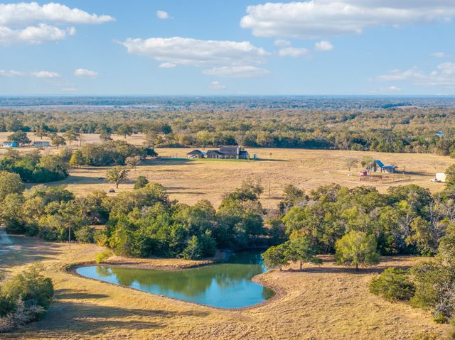 an aerial view of residential building and lake