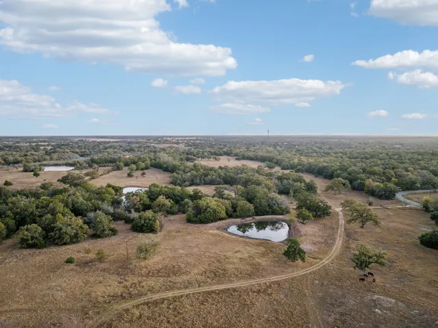 an aerial view of a house with outdoor space