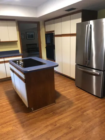 a kitchen with stainless steel appliances granite countertop a stove a refrigerator and a microwave