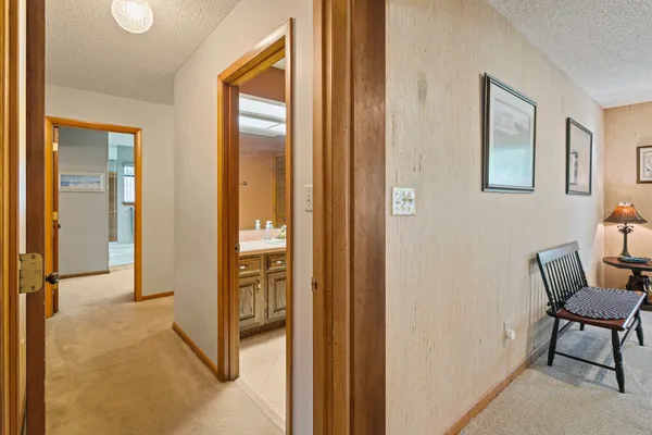 a view of a livingroom with furniture and a hallway