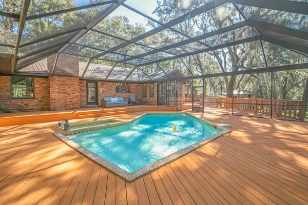 a view of a pool with a backyard