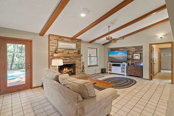 a living room with fireplace furniture and a flat screen tv
