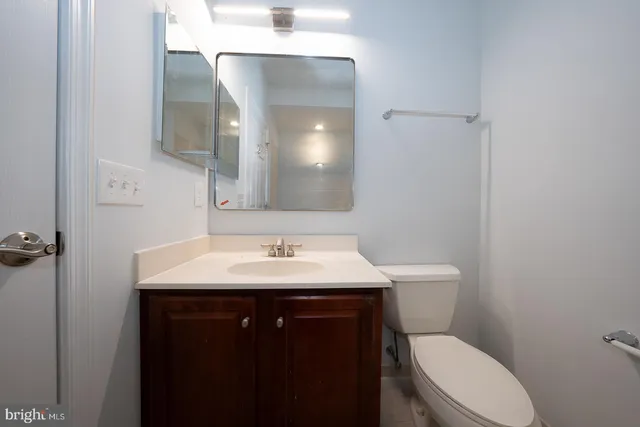 a view of staircase with railing and white walls