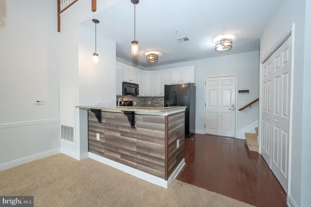 a view of kitchen with refrigerator stove and microwave