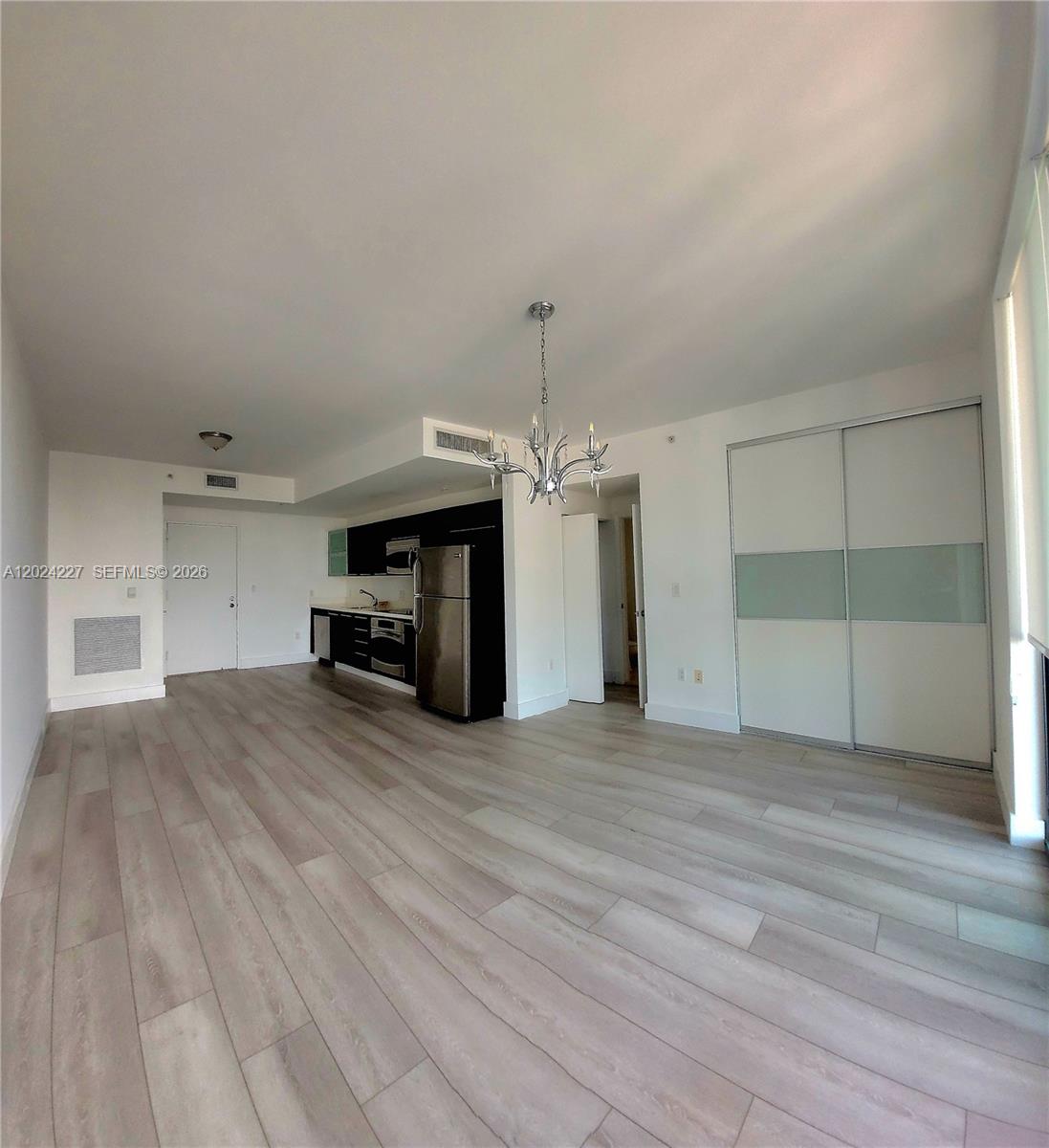 90 Southwest 3rd Street, Unit 2208 Miami, FL 33130 - Photo 12 of 56 a view of empty room with a fireplace and window