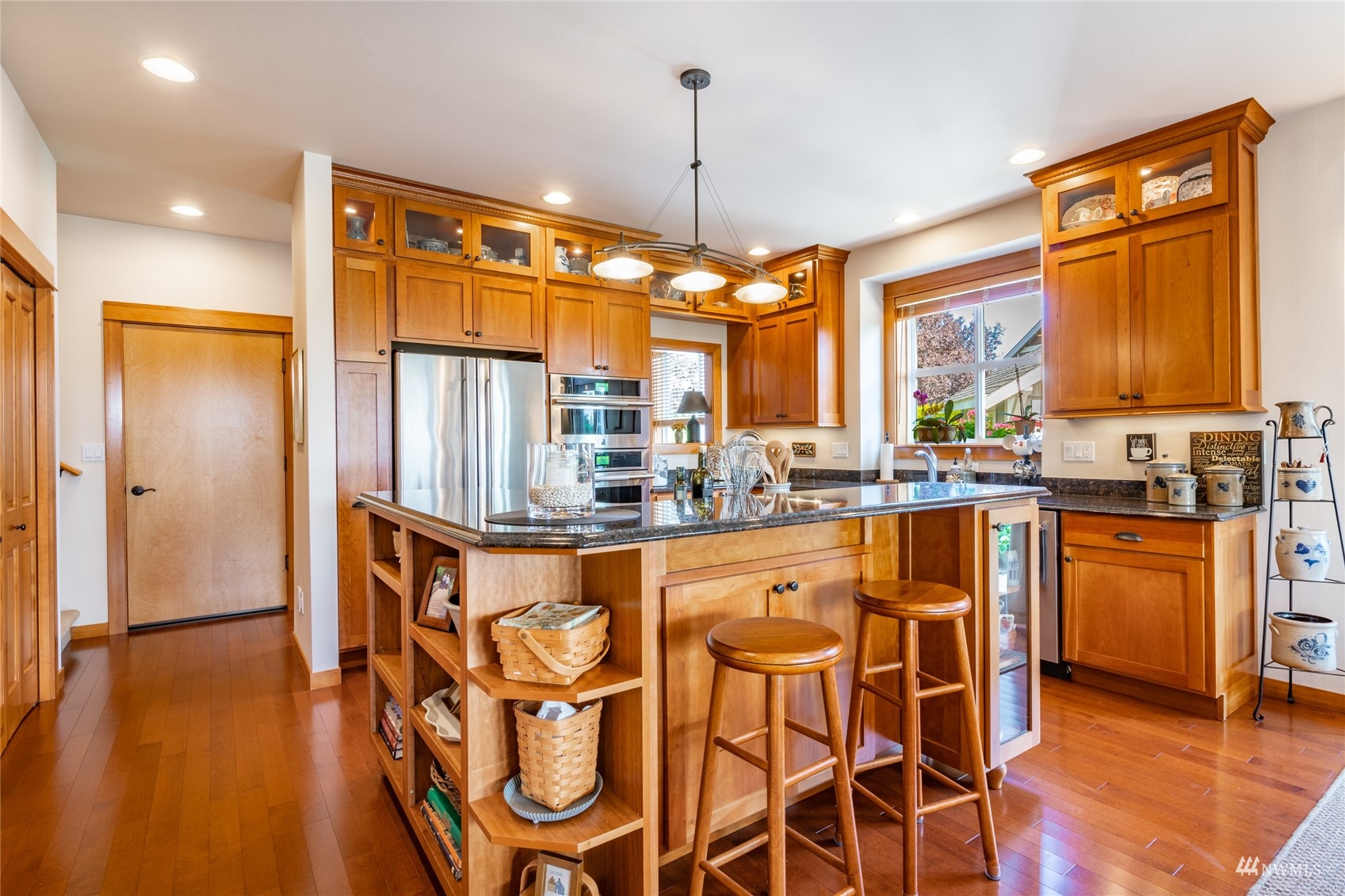 8858 Depot Road, Unit A Lynden, WA 98264 - Photo 11 of 40 a kitchen with stainless steel appliances granite countertop a refrigerator a sink a stove and island with wooden floor