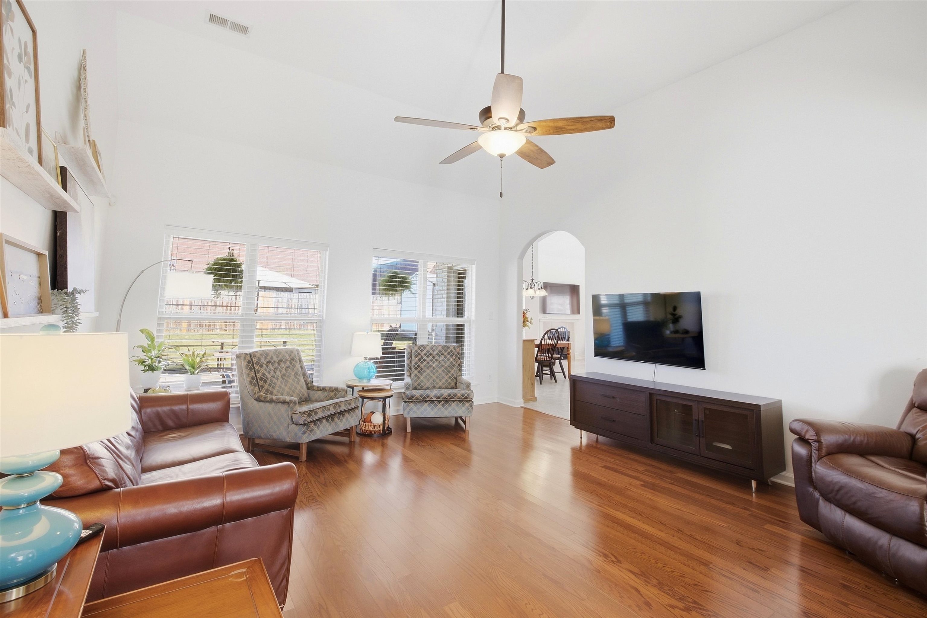 7920 Pips Ridge Lane Bartlett, TN 38133 - Photo 7 of 40 Vaulted ceiling, hardwood flooring, arched entryway, ceiling fan, and multiple windows