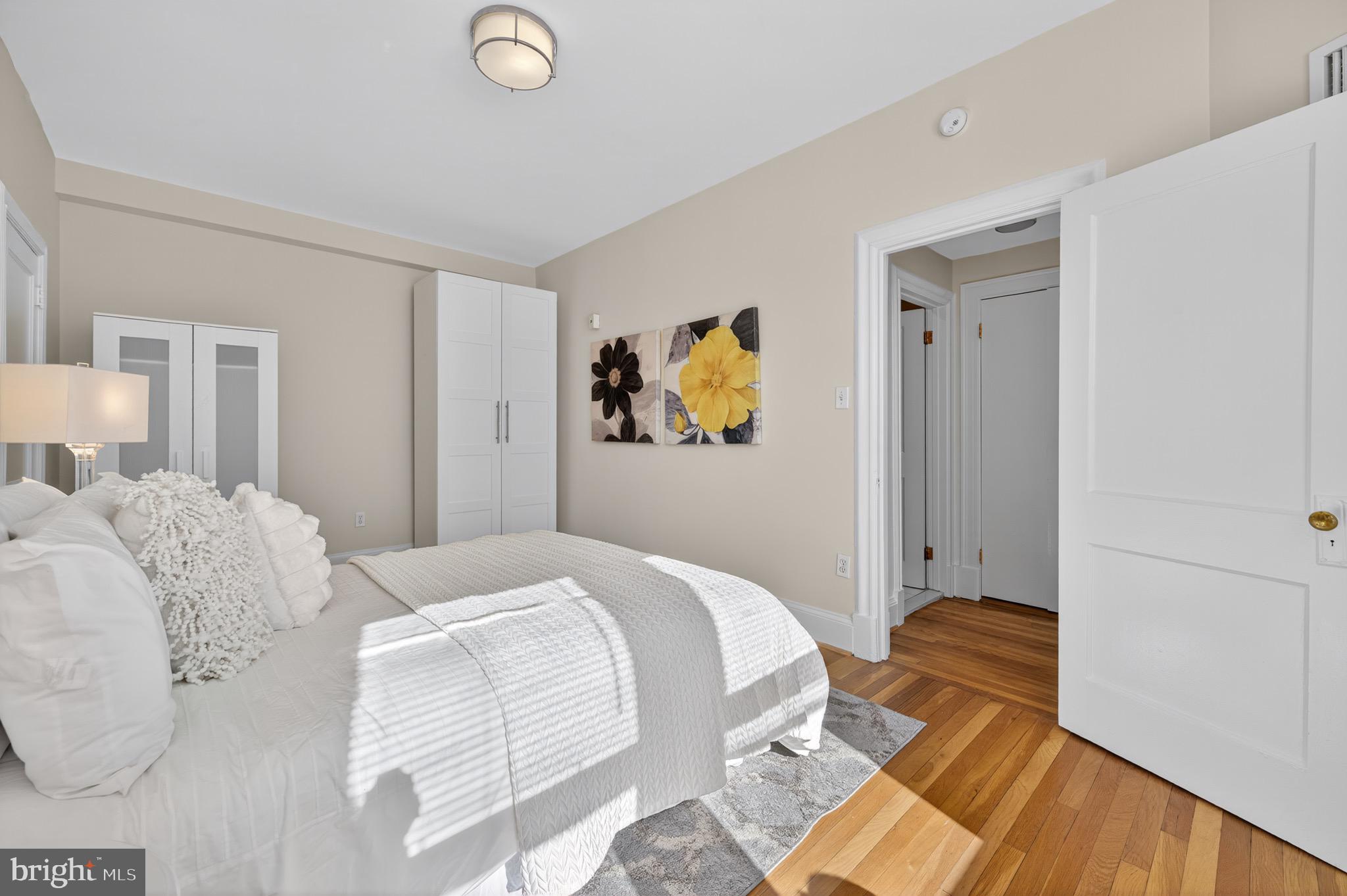 3446 Connecticut Avenue Northwest, Unit 305 Washington, DC 20008 - Photo 12 of 15 a bedroom with a bed and painting on the wall