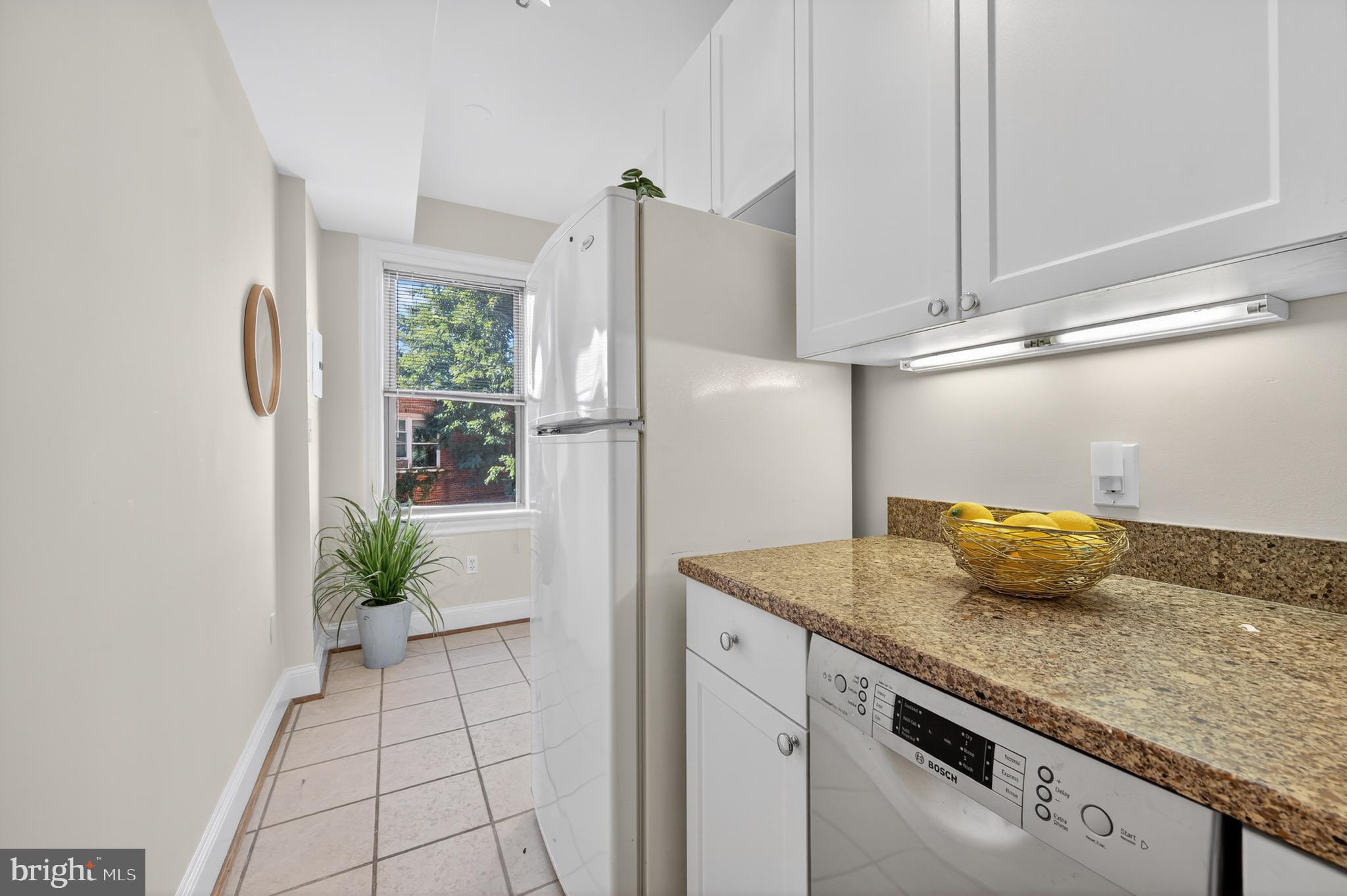 3446 Connecticut Avenue Northwest, Unit 305 Washington, DC 20008 - Photo 8 of 15 a kitchen with granite countertop a refrigerator and a counter top