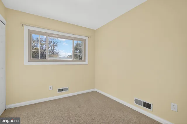 a view of an empty room with large window