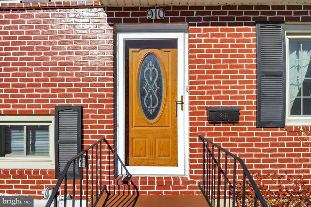 a front view of a house with a door and a rug