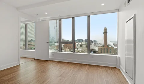 a view of a room with wooden floor and windows
