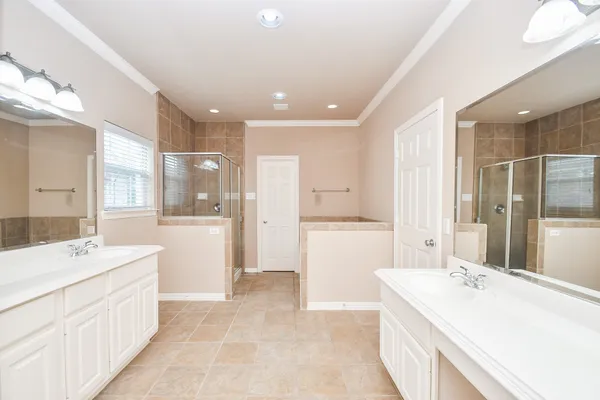 a bathroom with a sink a large mirror and a bathtub