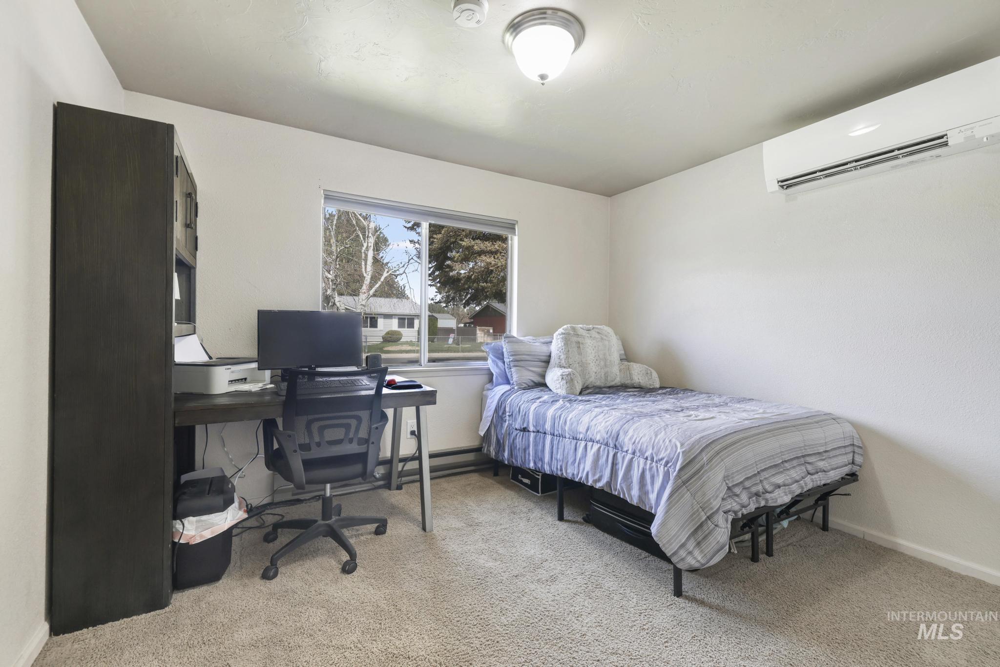 433 Ridgeway Drive Twin Falls, ID 83301 - Photo 11 of 18 Bedroom featuring a desk and light carpet