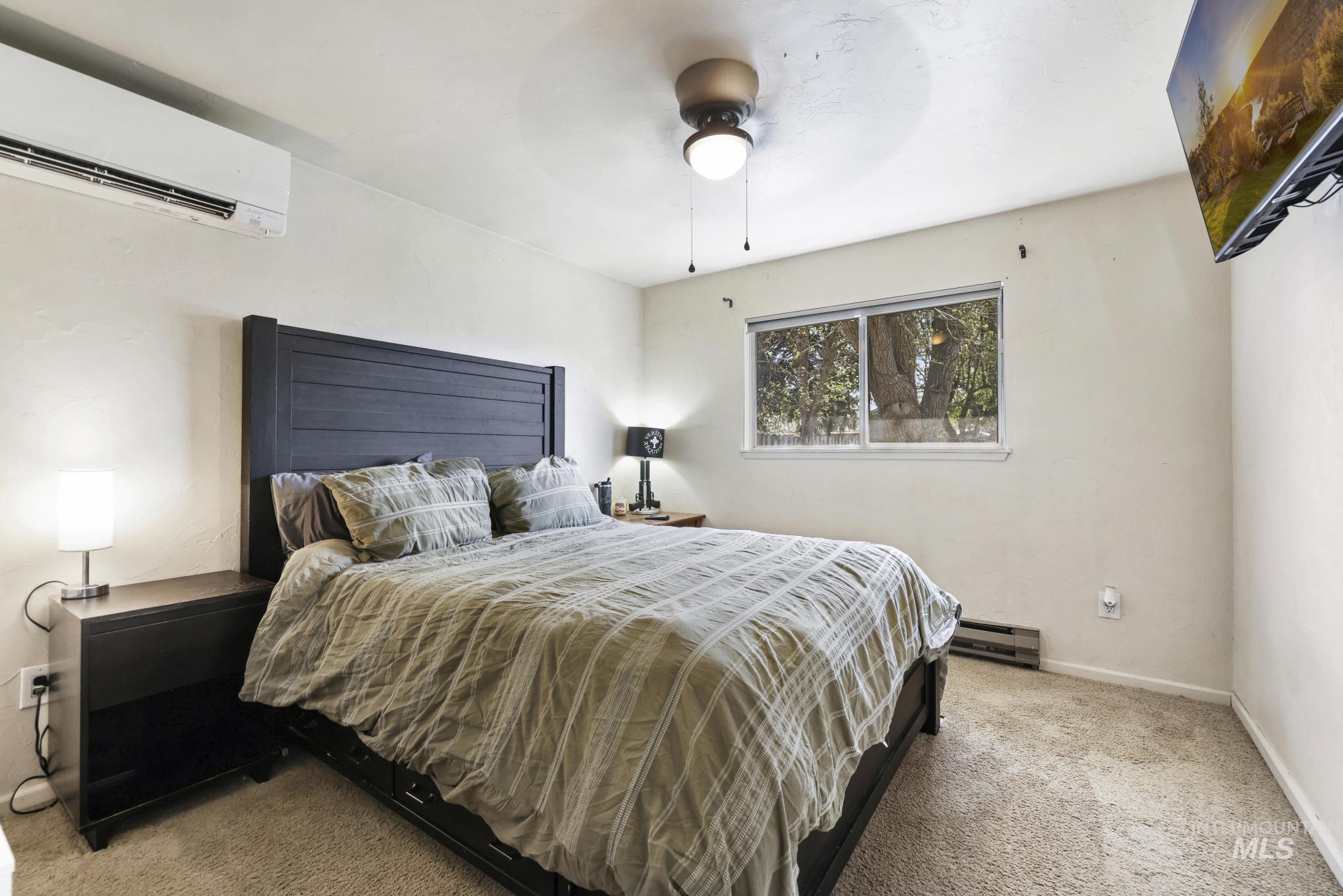 433 Ridgeway Drive Twin Falls, ID 83301 - Photo 12 of 18 Bedroom with carpet, a ceiling fan, and baseboard heating