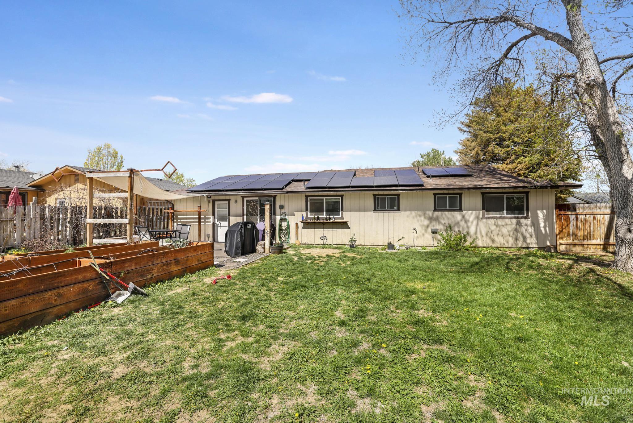 433 Ridgeway Drive Twin Falls, ID 83301 - Photo 17 of 18 Back of property featuring solar panels and a fenced backyard