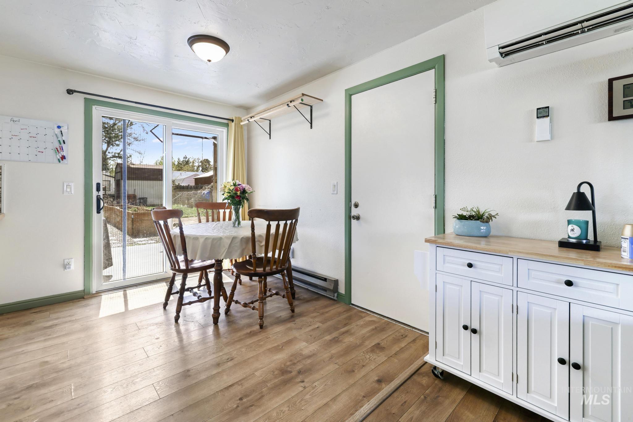 433 Ridgeway Drive Twin Falls, ID 83301 - Photo 4 of 18 Dining area with a mini split for heating / cooling, dark wood-style flooring, and a baseboard heating unit