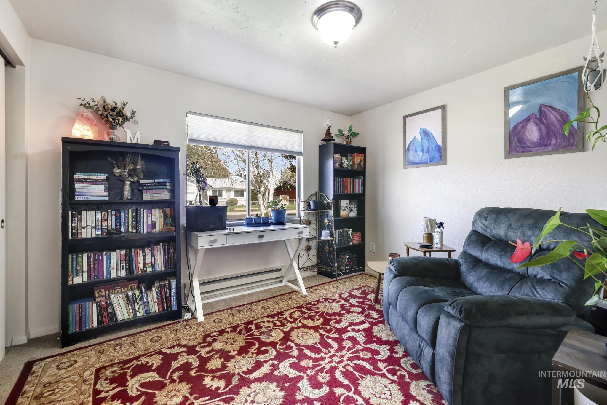433 Ridgeway Drive Twin Falls, ID 83301 - Photo 9 of 18 Living area with light carpet and a desk