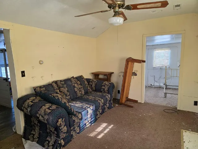 a living room with a couch and a chandelier