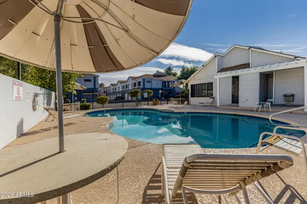 a swimming pool with outdoor seating and yard