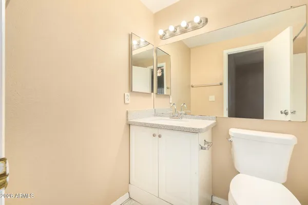 a bathroom with a toilet a sink and mirror