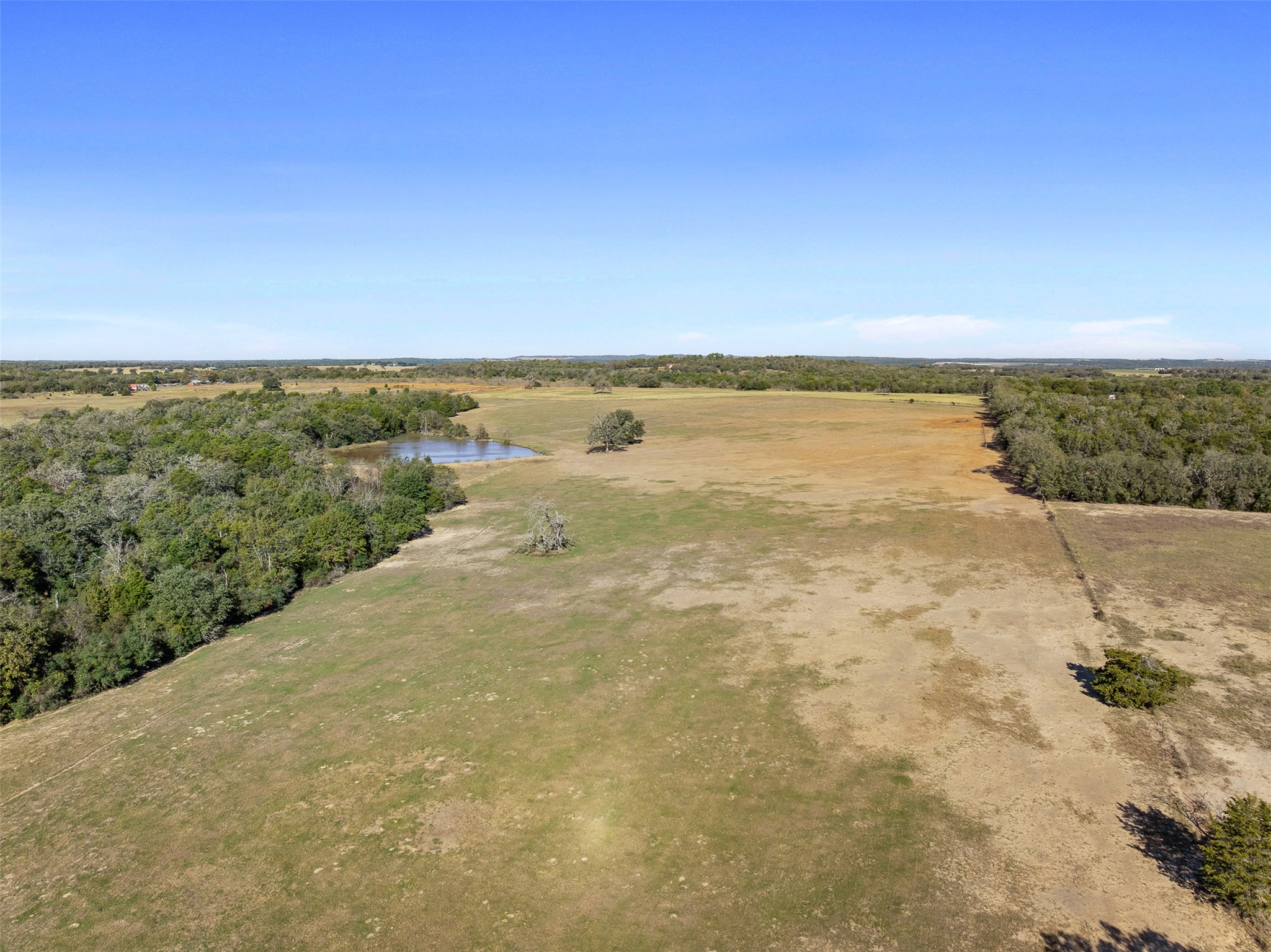 0 Stockade Ranch Road Paige, TX 78659 - Photo 16 of 37 Aerial view of sparsely populated area featuring a large body of water