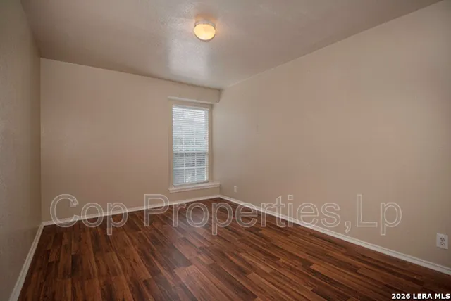 a view of a room with wooden floor