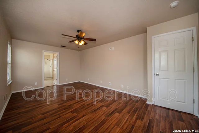 a view of an empty room with wooden floor