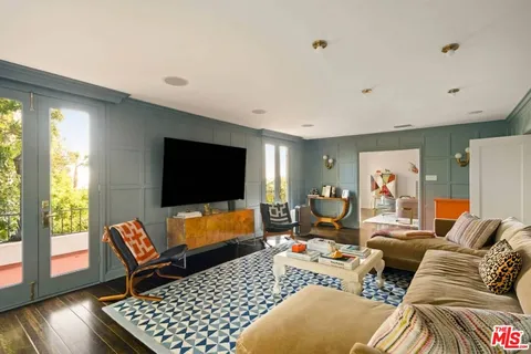 a view of a living room with furniture and wooden floor