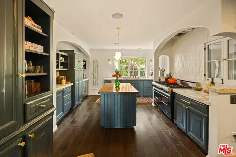 a kitchen with a sink and large window