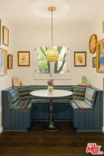a view of a living room with a table and chairs