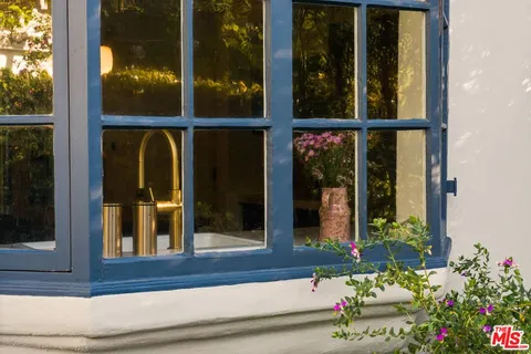 a bathroom with a sink mirror and a window