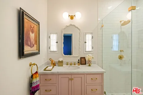 a spacious bathroom with a granite countertop sink a mirror and a bathtub
